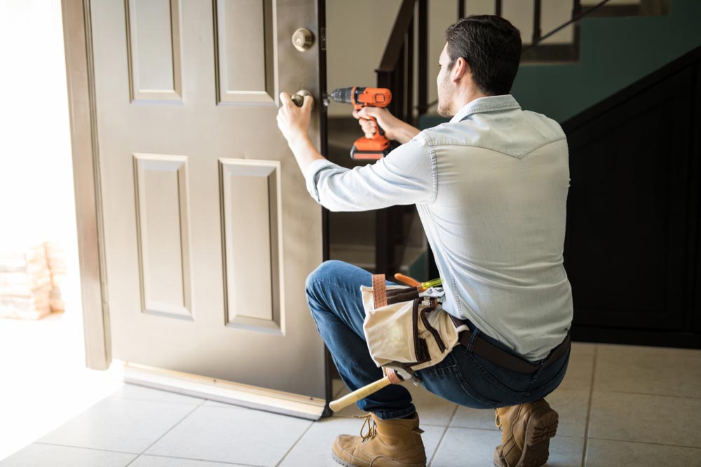 A professional handyman ensuring proper door repairs with expertise and safety measures.