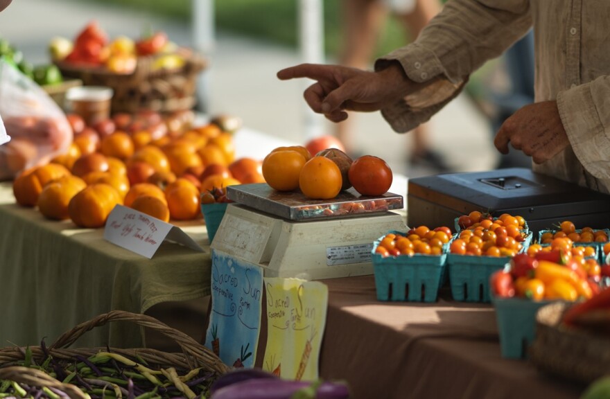 Discover distinctive local produce offerings like these freshly weighed tomatoes at Kansas City's farmers markets.